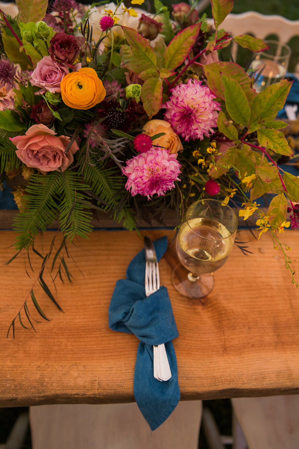 knot denim napkins for your place settings on a farm table with lush center pieces - Pearl Weddings & Events