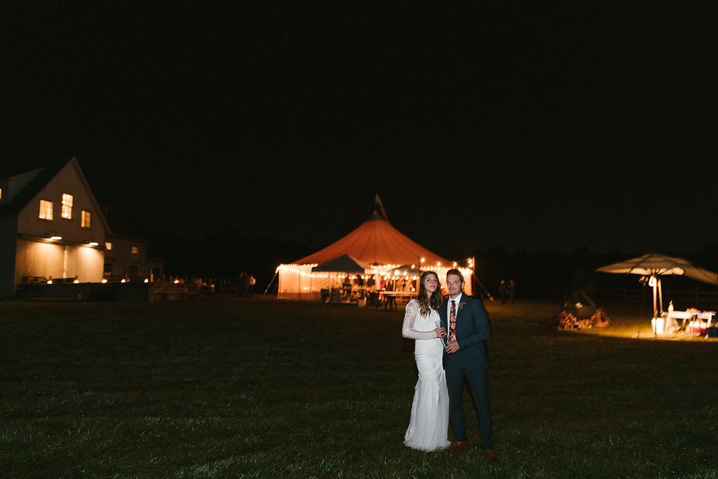 late night photo of the bride and groom with their tent in the background! - Pearl Weddings & Events