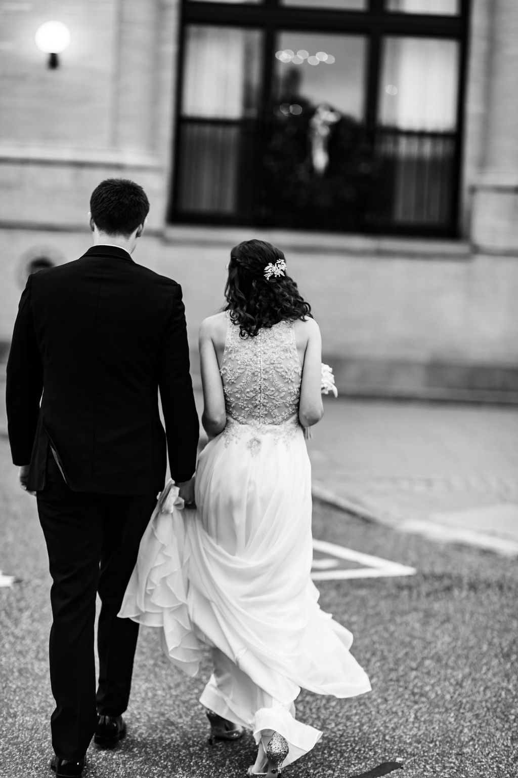 When the groom carries the brides dress so she doesn't trip - Pearl Weddings & Events