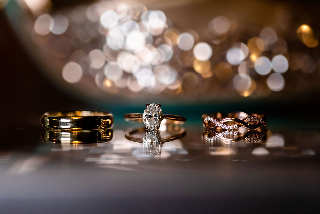 Rose gold and gold wedding and engagement rings for the bride and a gold band for the groom. - Pearl Weddings & Events