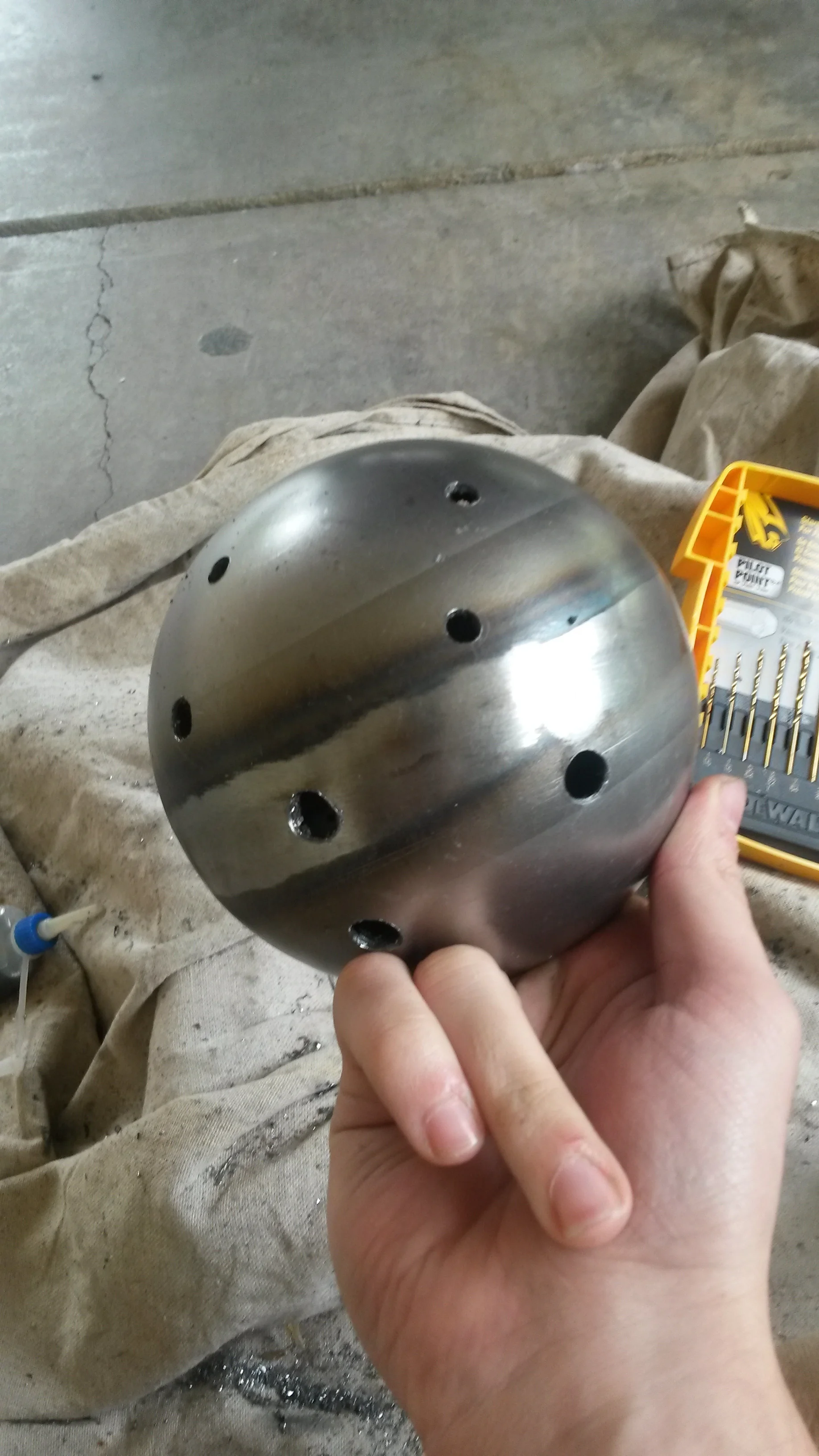 To allow light to come through, I bored several holes around the surface of the sphere. The holes are of varying sizes, and are arranged to be connected.