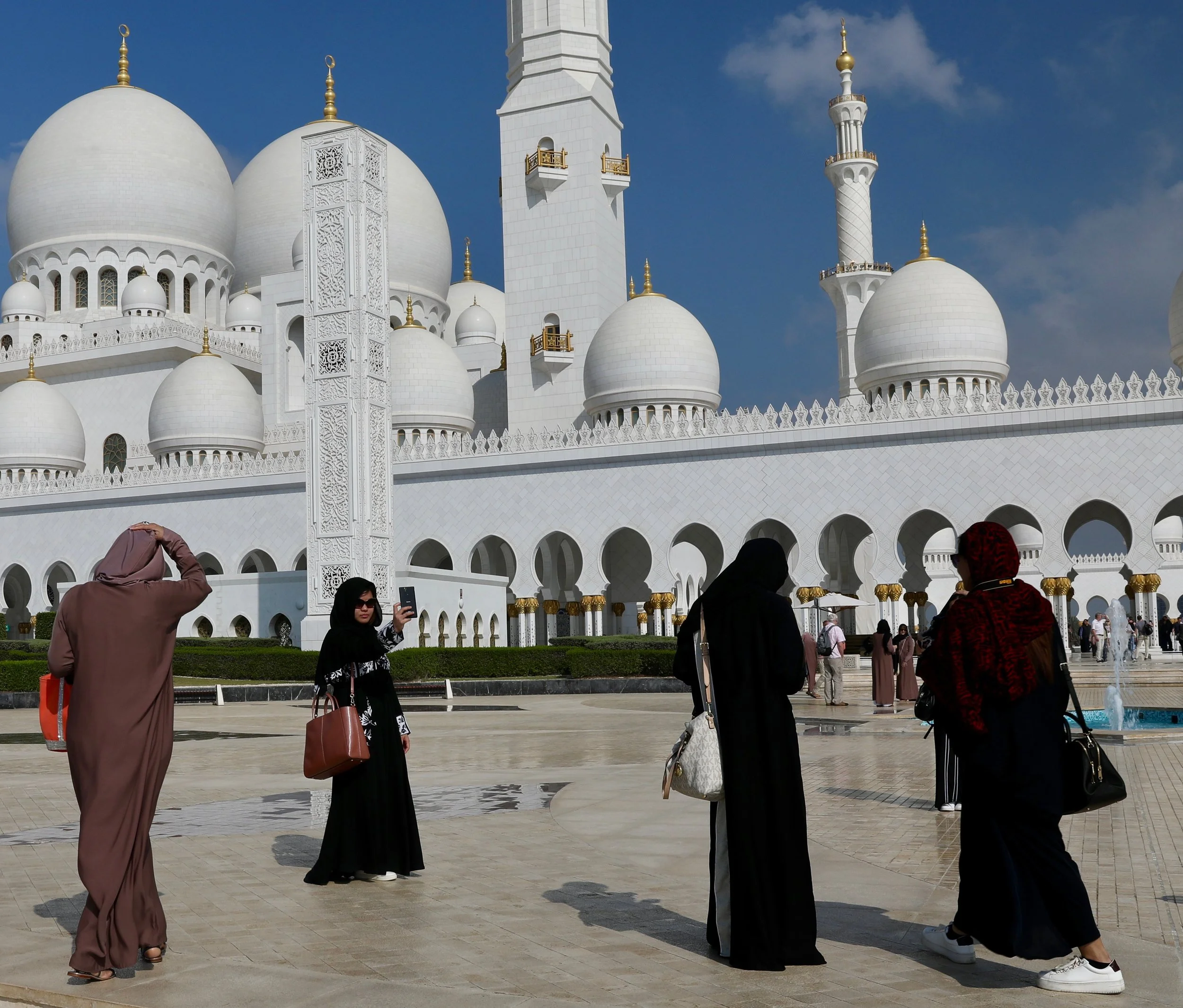 a woman takes a selfie outside of the grande mosque