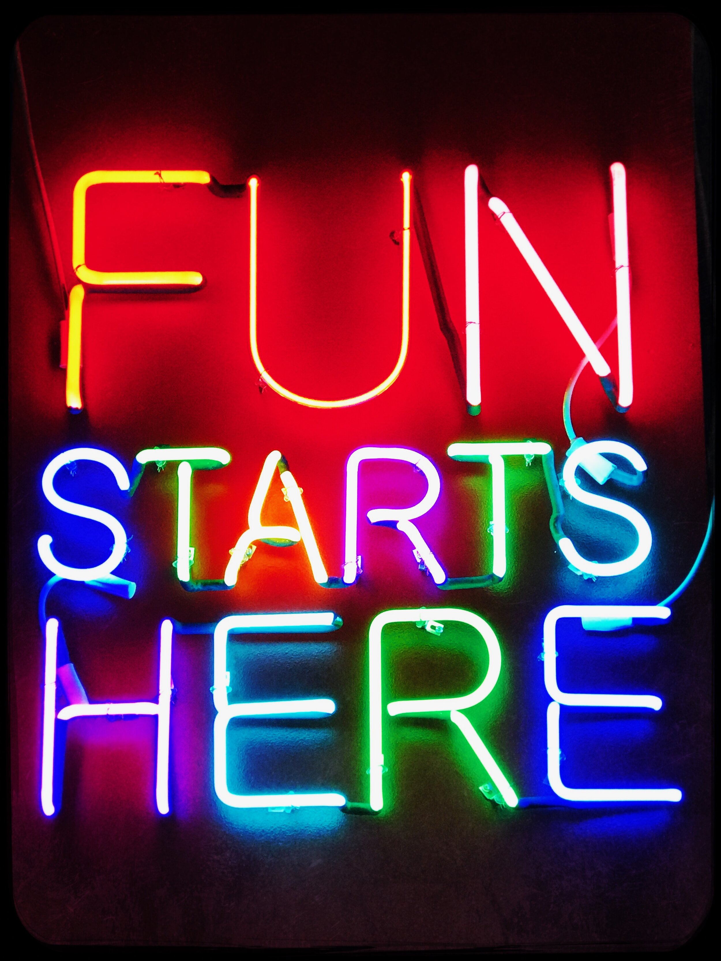 Colorful Neon sign Fun Starts Here