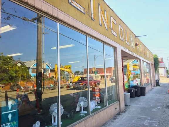 Lincoln Hardware's wide front windows reflect the reconstruction of S. G St.
