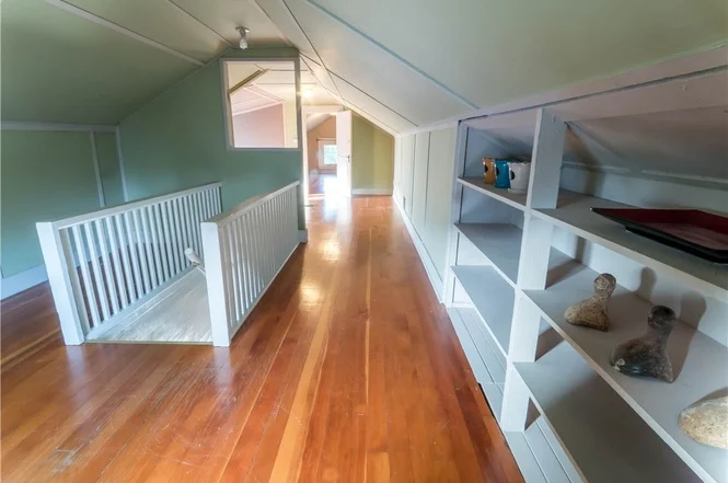Upper floor landing and bedroom also shine with fir floors. 