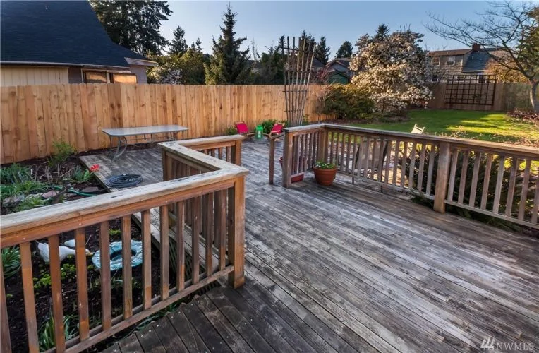 Large deck from kitchen and new cedar fence.