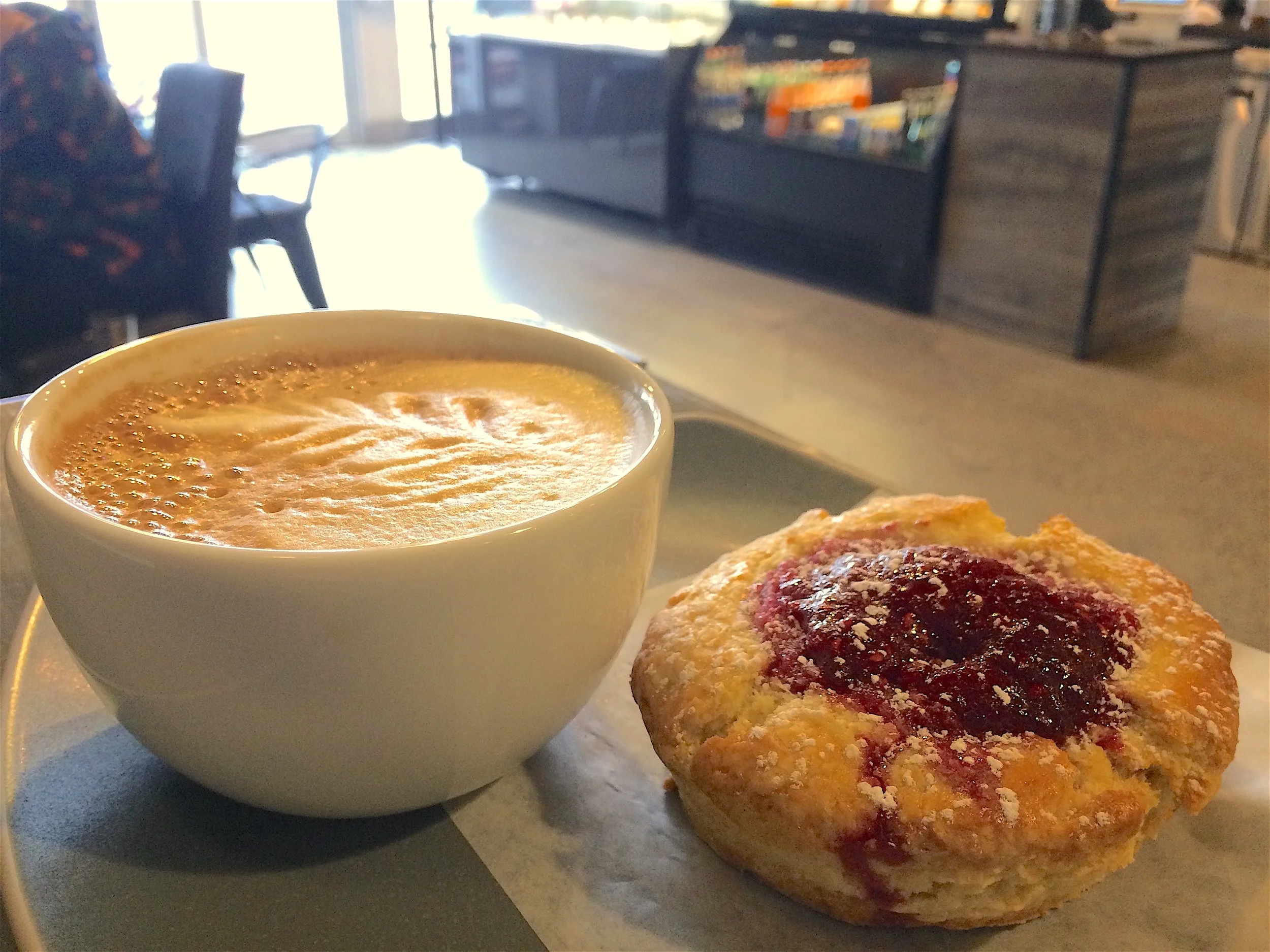 Warm scone with raspberry jam and a latte. The jam tasted bright with a little bit of lemon, like homemade freezer jam. 