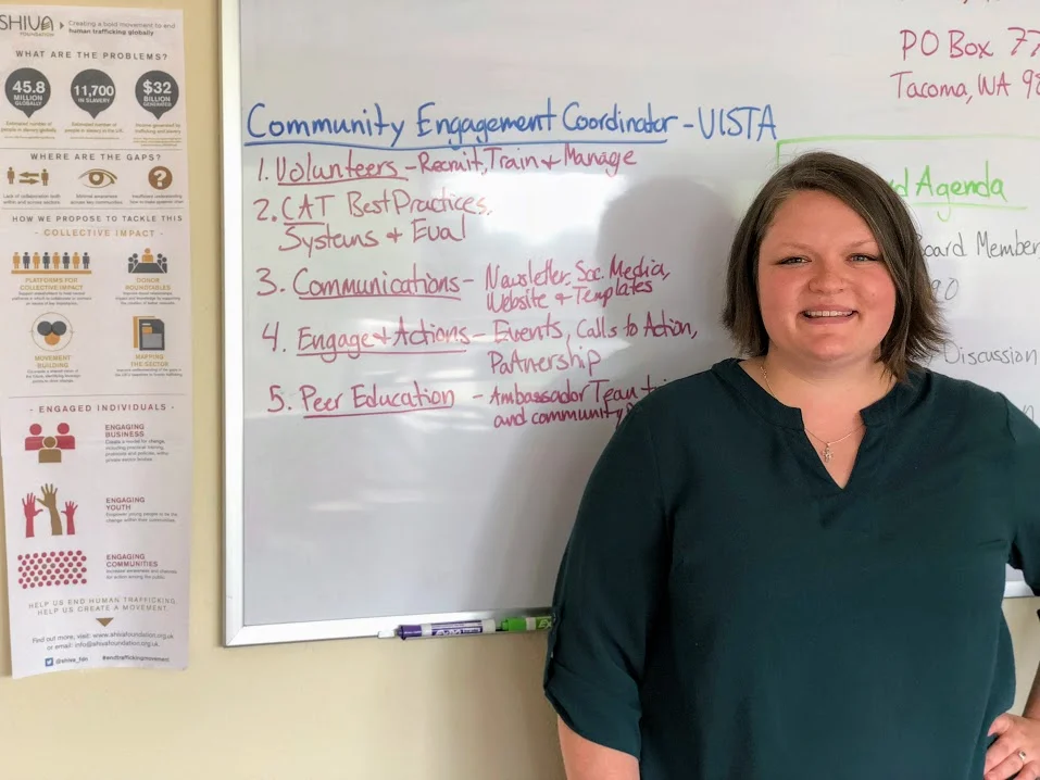 Kerri in front of the working white board at the WTP Office in Tacoma, WA.