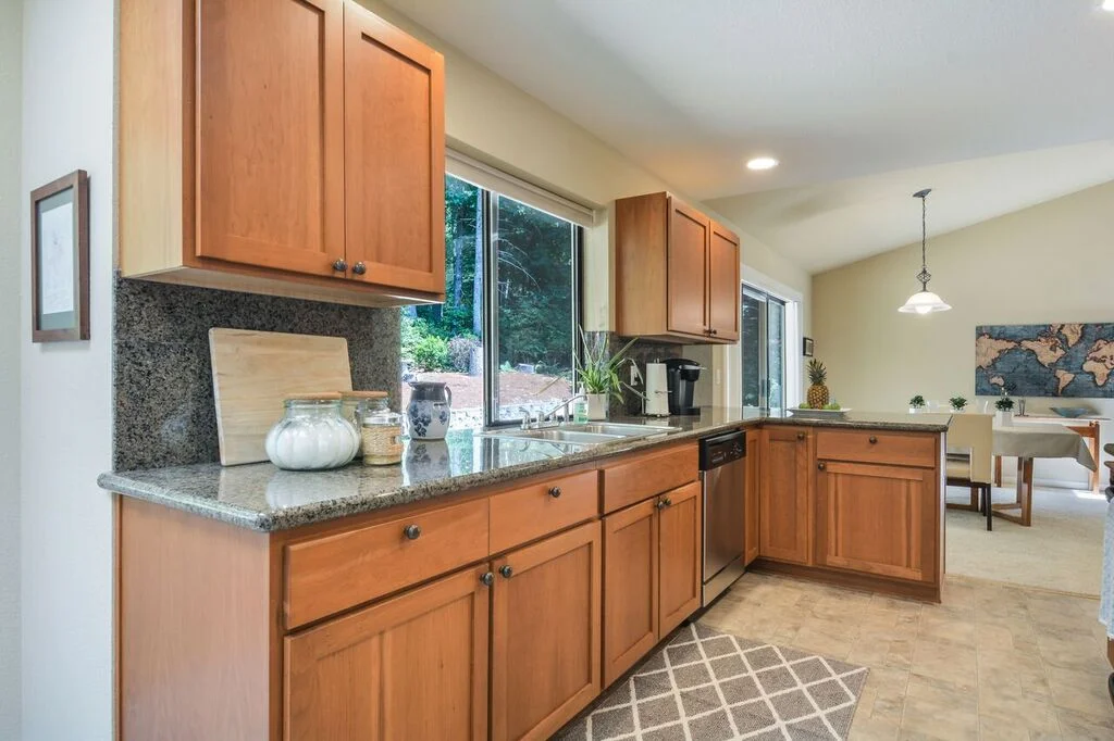 Easy to clean vinyl floor, big windows over the sink, and generous cabinets for storage.