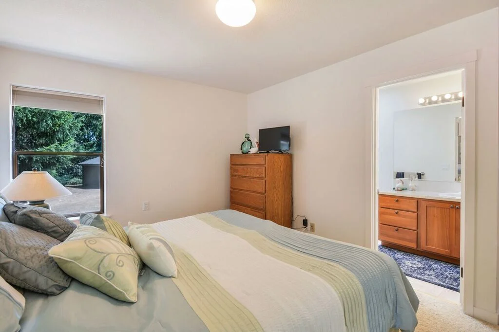 This back bedroom suite features a private 3/4 bath, windows overlooking the back and side yard, and generous closet space.
