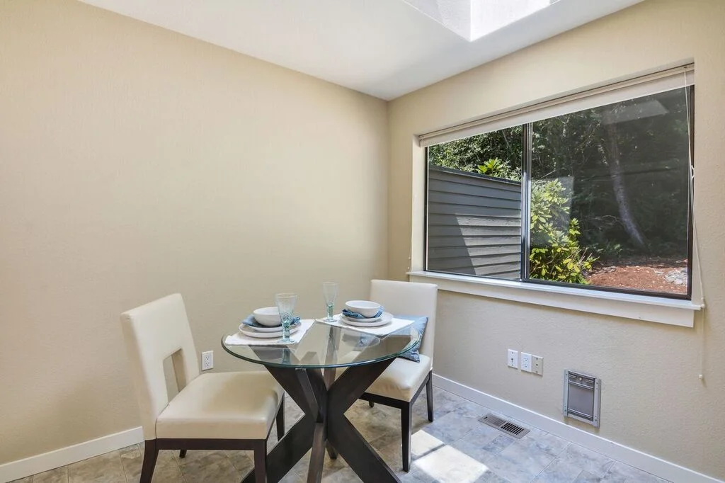 Set a table in the eat-in kitchen's breakfast nook for a cozy kitchen meal lit by the skylight above.