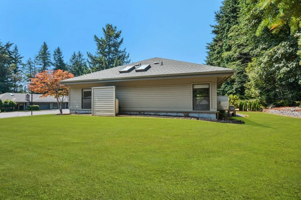 The front lawn wraps around to this side yard and connects to the private back area. This side of the lot is open to let sunshine in.