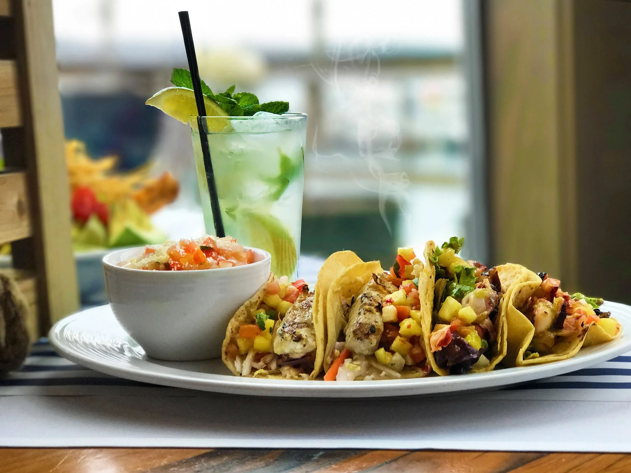 Get tacos, fish and chips, or burgers (and you can choose beef, chicken, or veggie patty!) with a pretty water view. Image from Boathouse 19