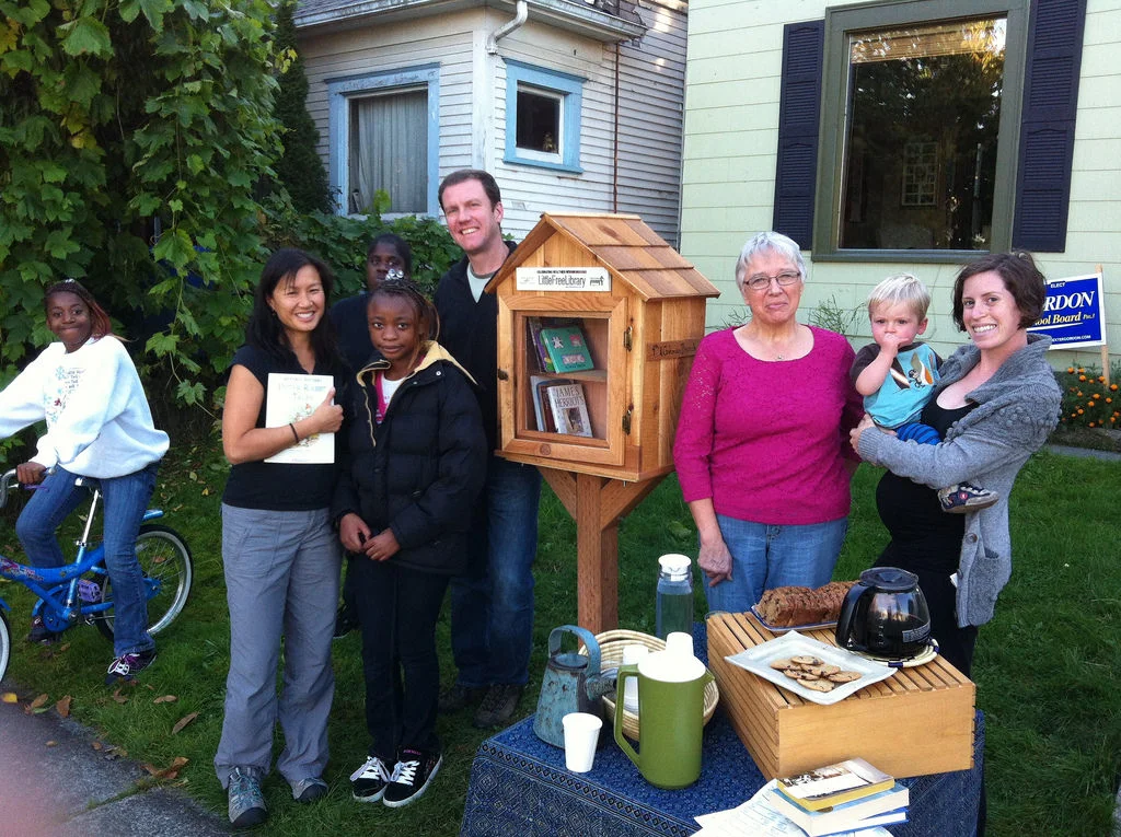 Image from LittleFreeLibrary.org . Leigh and John gathering with a group of neighbors to celebrate their Little Free Library.