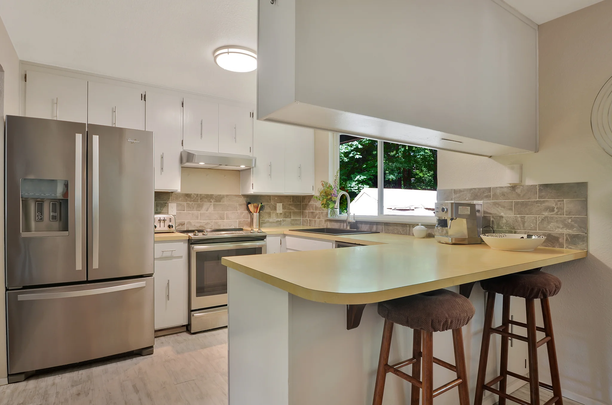 Bar stools are a great spot to stick your friends or kids while getting meals or a snack ready. This design also ensures a good amount of counter space for chopping, stirring, and baking. The new refrigerator has a water filter, ice maker, and freezer drawer.