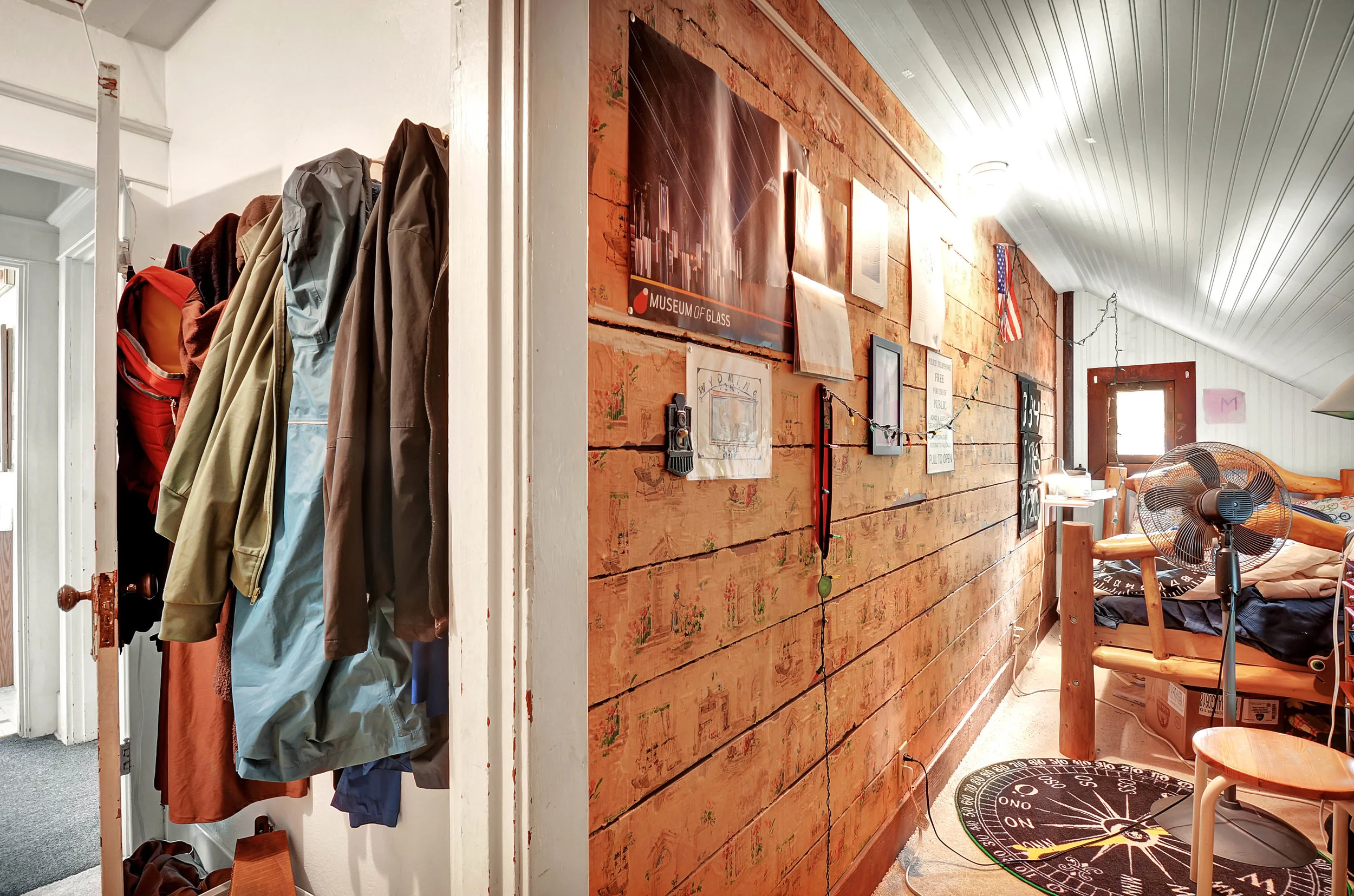 This 3rd upstairs bedroom is all character with its vintage wallpaper, beadboard, and entry through the closet.