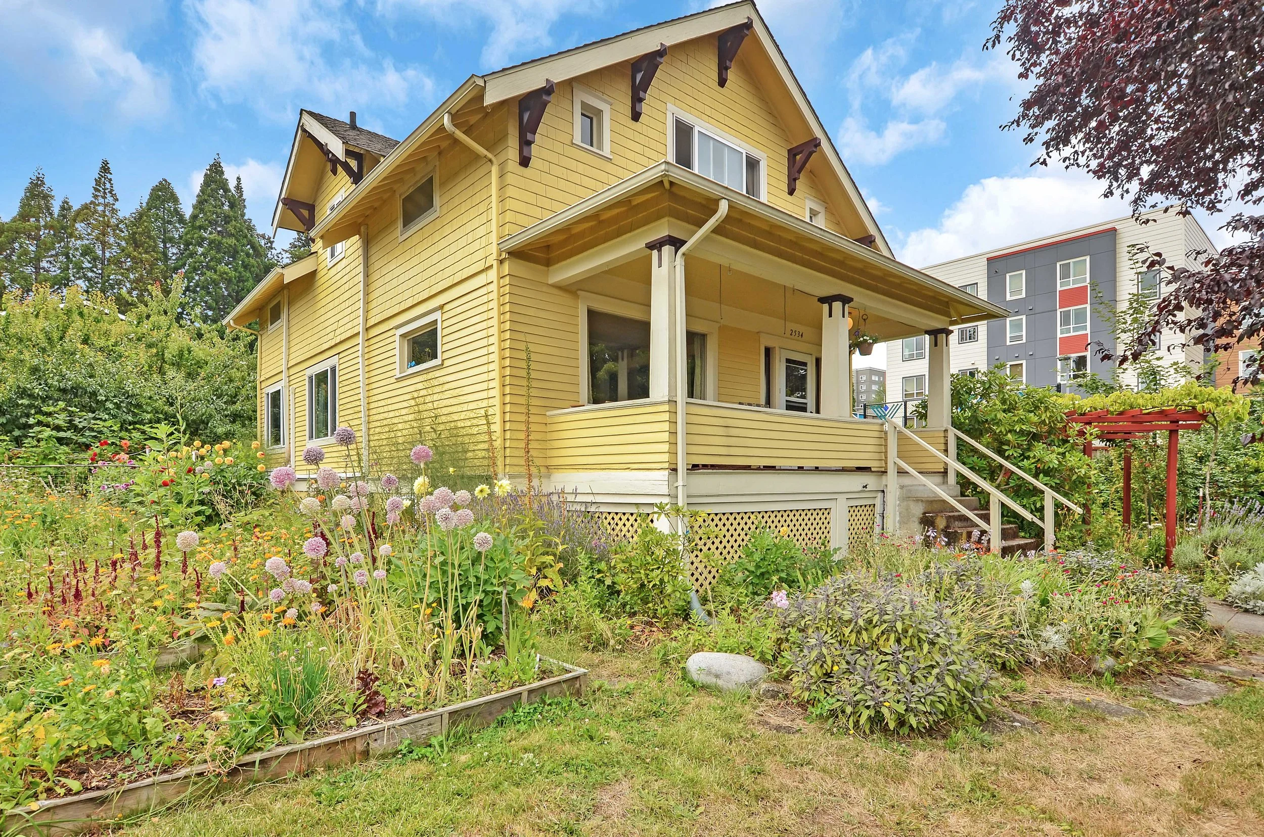 Garden space surrounds this home on its 12,000 sq ft lot. Full of life, flowers, fruit, and berries with evergreen and deciduous trees, you can’t miss the changing of the seasons in a yard like this where the plants tell the story.