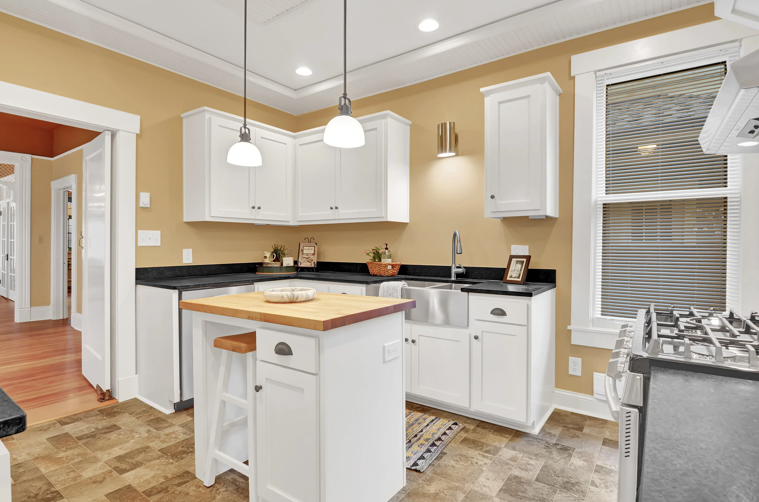 A farmhouse sink, 5 burner gas stove with griddle, and under-cabinet lighting, are just a few of the thoughtful kitchen details.