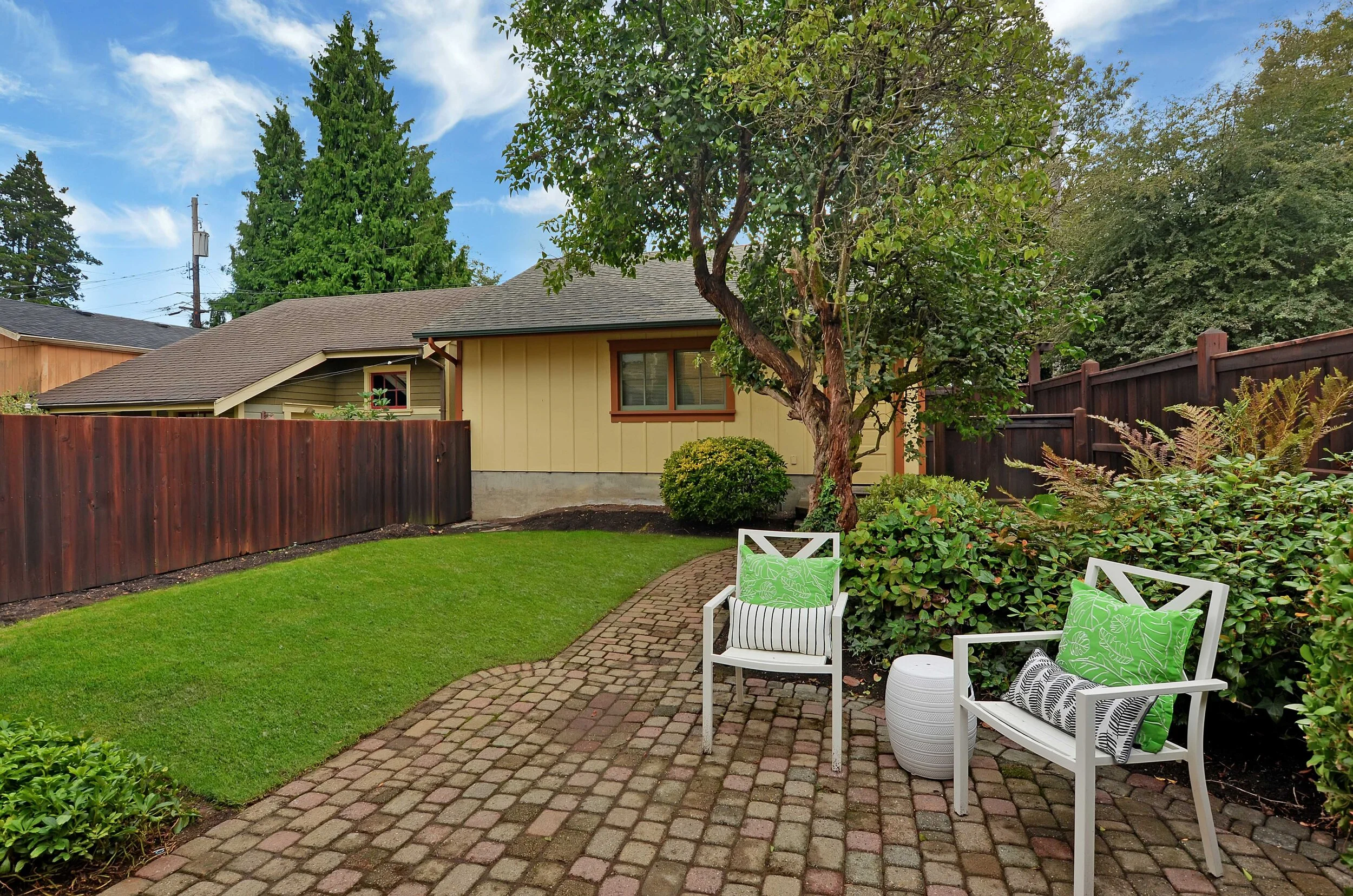 Here you see the friendly garden side of the garage with the cobblestone path bending toward it.