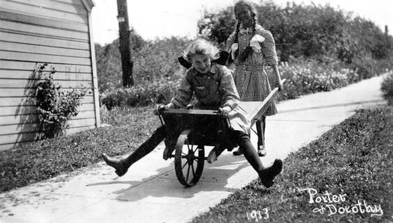 A spunky image of timeless fun depicting the young girl raised in this very house playing out on the sidewalk.