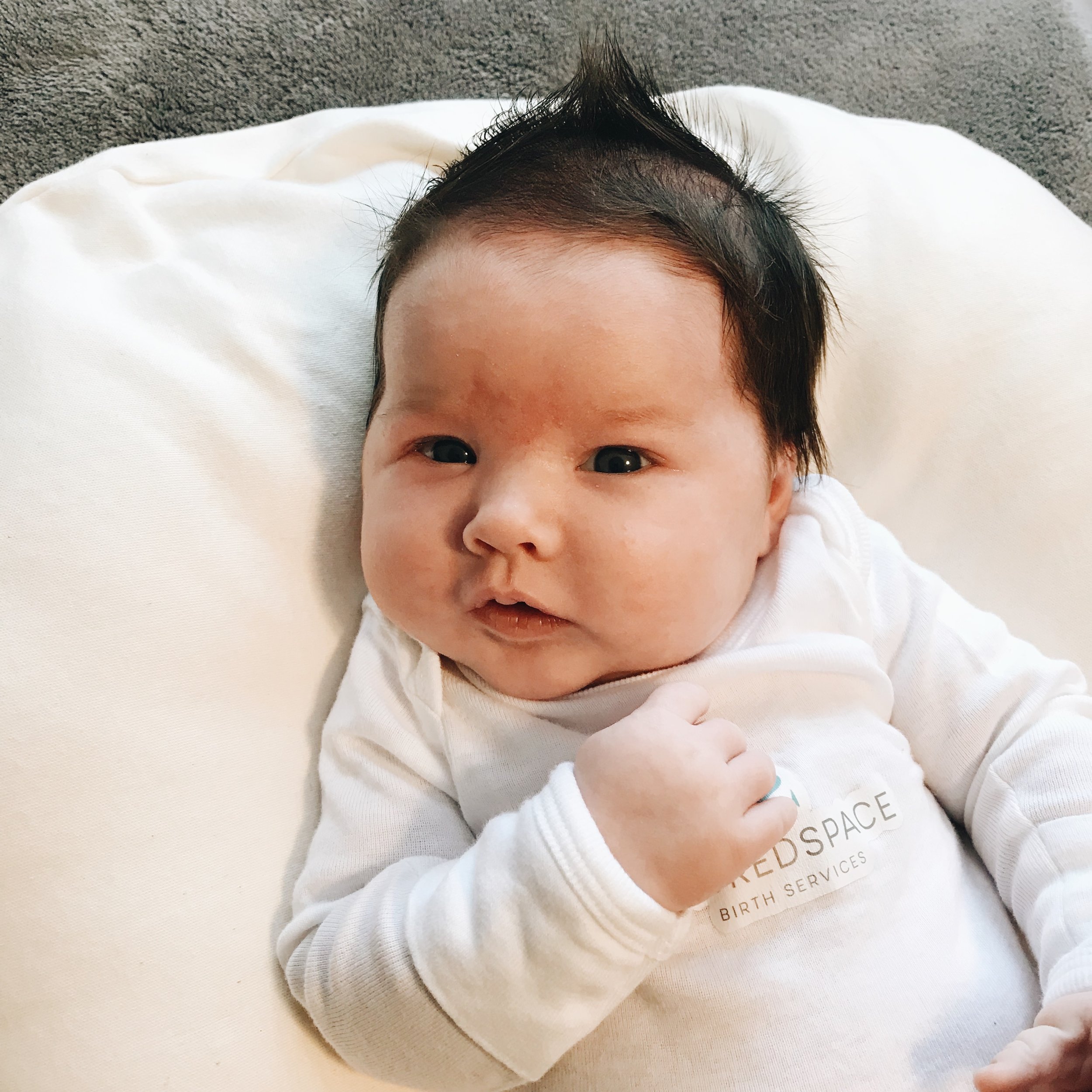 Lora in her Sacred Space Birth Services onesie