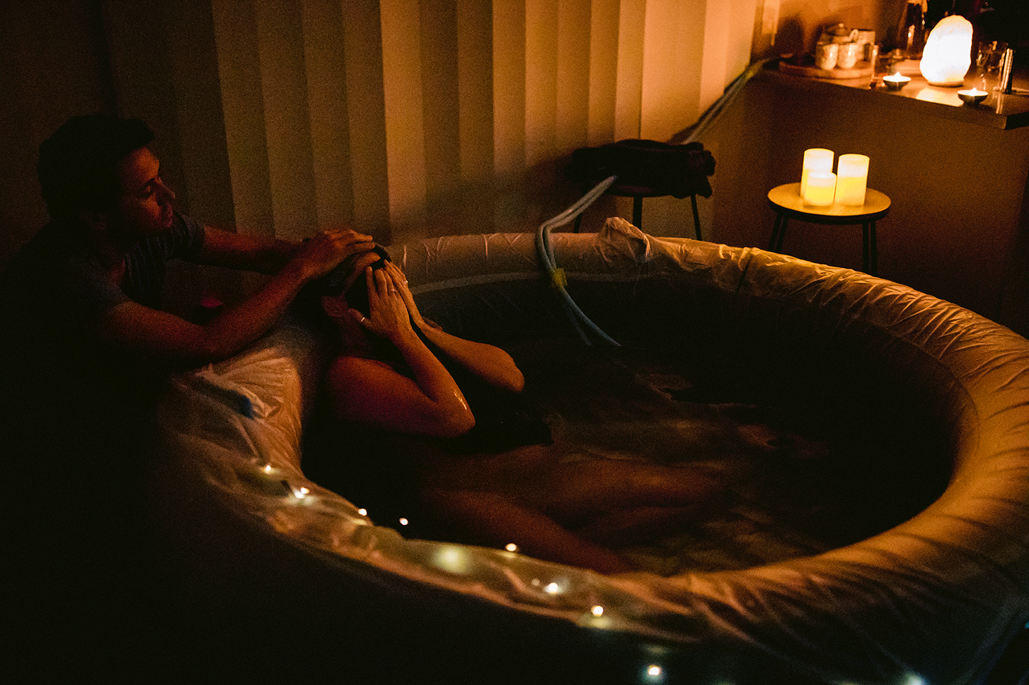 Example of a dark room with the only light coming from candles and a salt lamp.