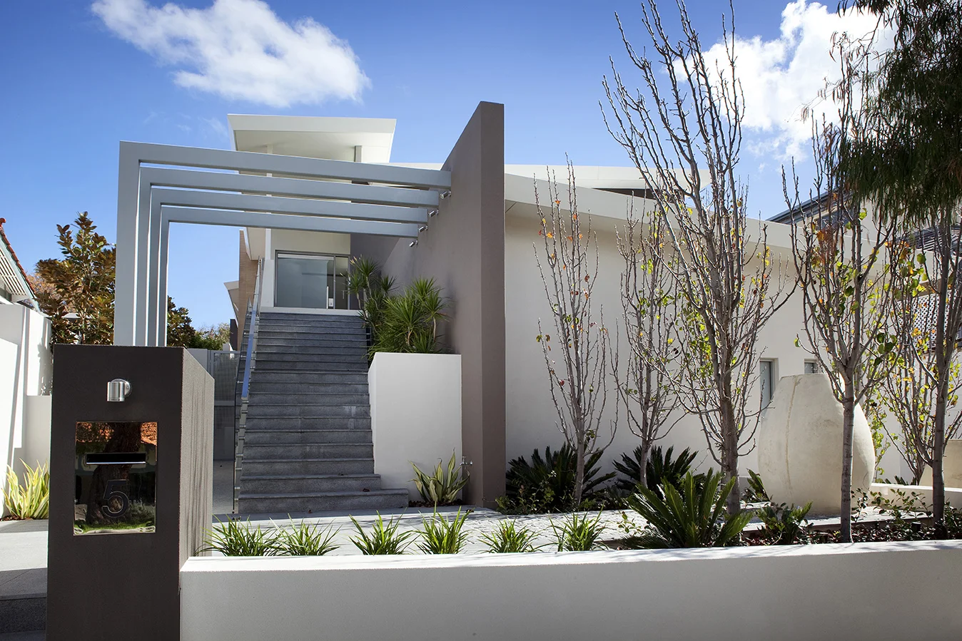 The crisp new front entry to the Cottesloe residence 10 years ago. New landscaping breaking up the new architecture.