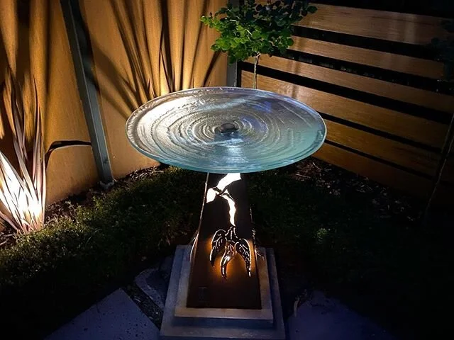 Flowering gum birdbath with slumped glass dish and internal LED lighting #gardenart #birdbath #landscapedesign #gardenlighting