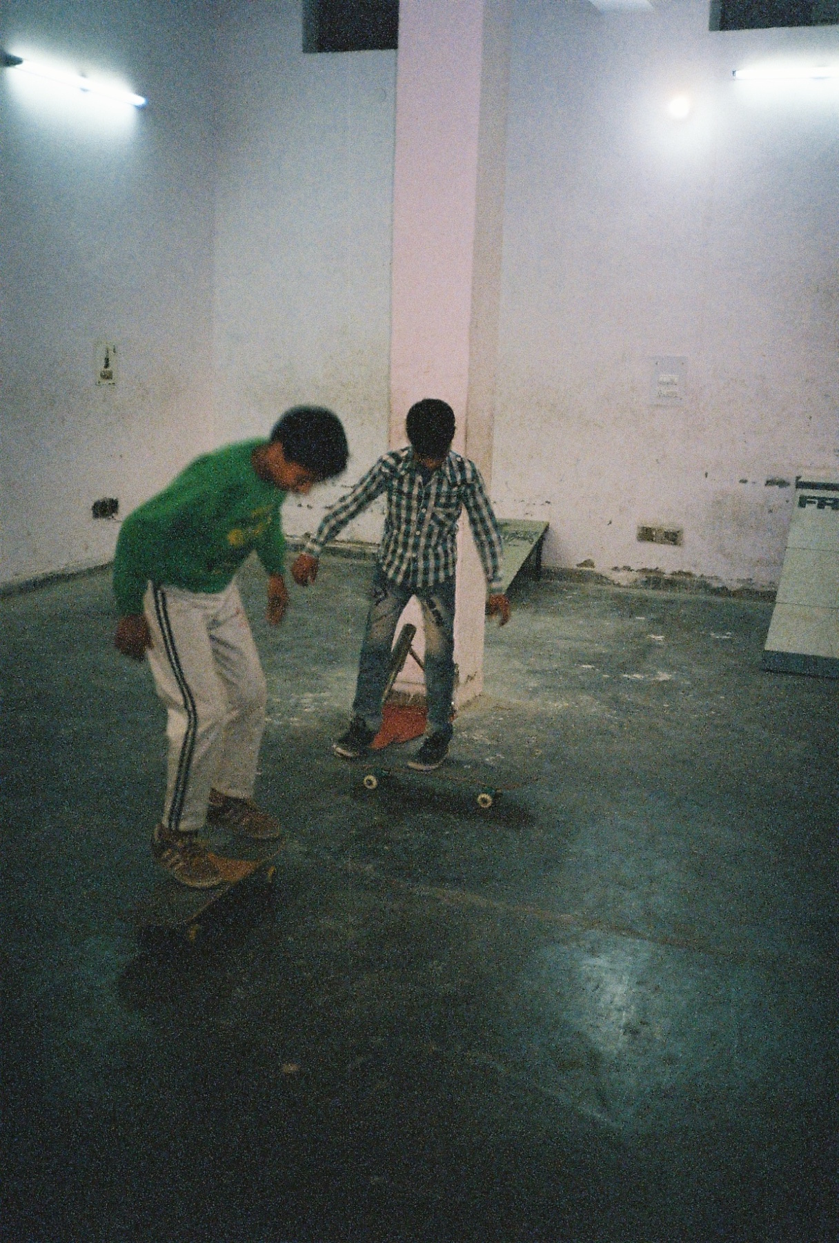 KIDS SKATING IN A MAKE SHIFT PARK IN A WAREHOUSE BASEMENT IN THE OUTER SUBURBS OF NEW DELHI.jpg