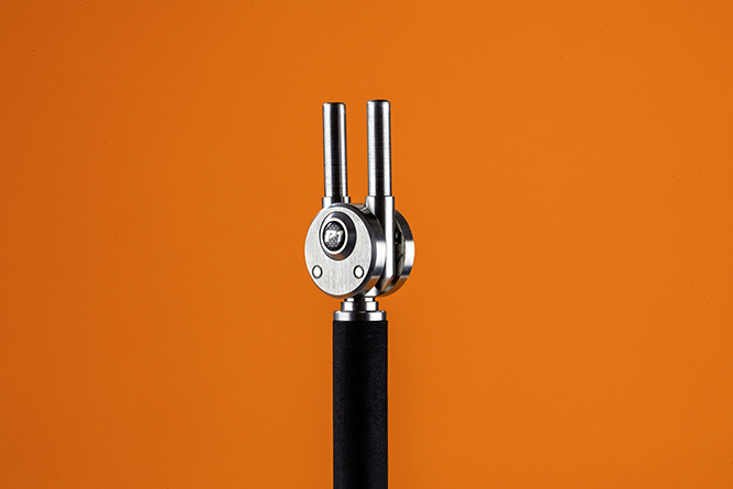 The machined stainless-steel block and quick-release arms