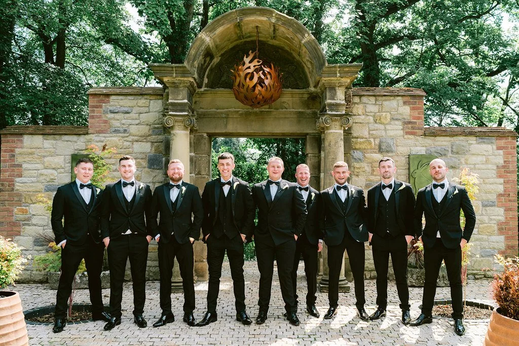 The Loft outdoor space and gardens, groomsmen in black suits