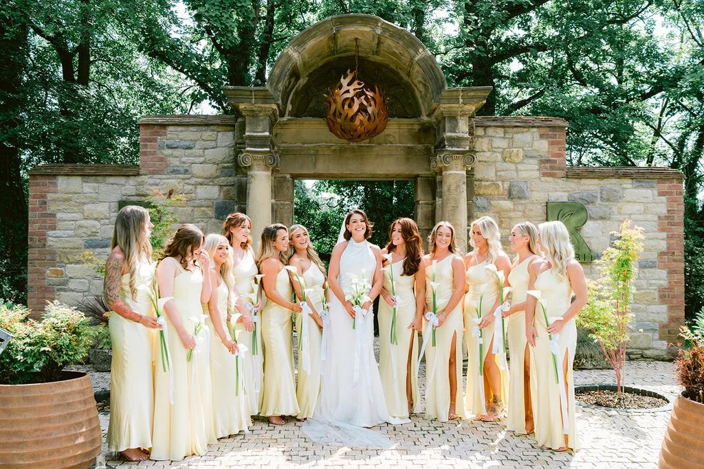 The Loft outdoor space and gardens, bridesmaids in yellow dresses