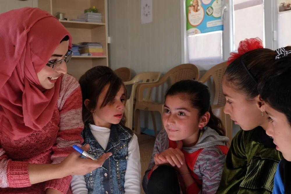  Yazidi children discussing pain points and coming up with design ideas during a co-creation session. 