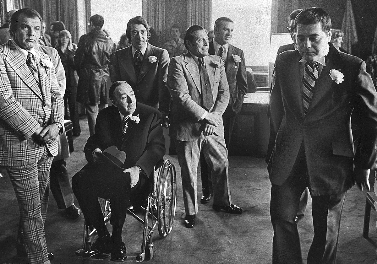 Buddy, right, hurries around his office as he prepares for his inauguration ceremony on January 7, 1975. Among the guests is Larry McGarry, the chairman of the local Democratic Party, in a wheelchair. McGarry was one of the major power players who helped win Democratic support for Buddy. He even allegedly called upon mob enforcer Jerry Tillinghast to help round up votes. Providence Journal file photo/Thomas D. Stevens