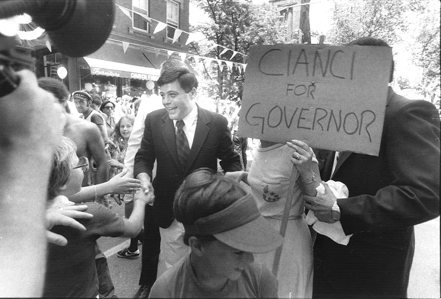 Onlookers rush to greet Buddy Cianci during his run for governor. In the summer of 1980, a fiscal crisis in Providence undermined his popularity and doomed his campaign. Courtesy of the Providence Journal/Andrew Dickerman.