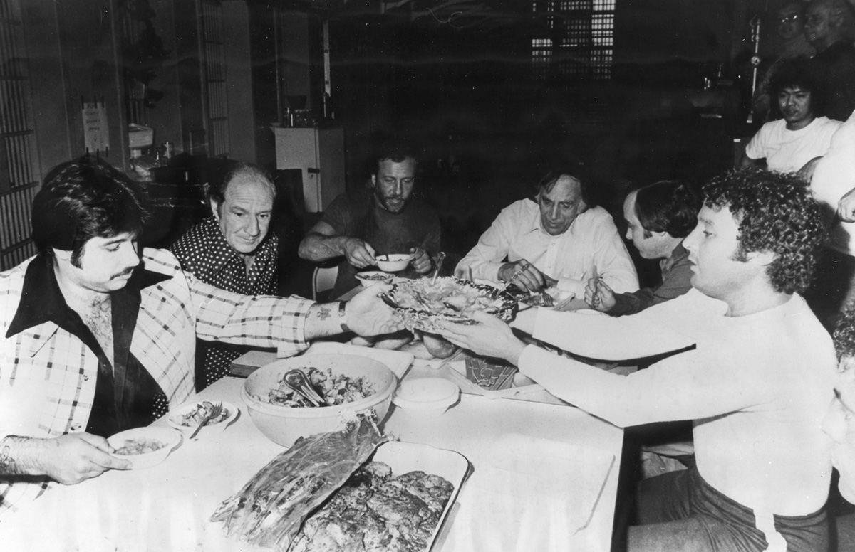 George Basmajian , far left, enjoys a lavish meal at the Adult Correctional Institutions with other wiseguys in the early 1970s. Courtesy of the Providence Journal.