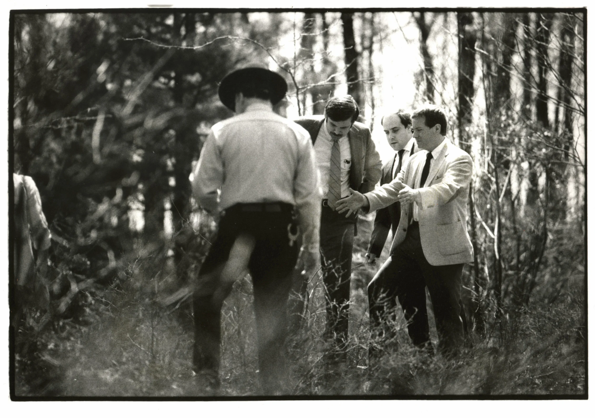 Rhode Island Assistant Attorney General Michael Burns, right, gestures over a hole in Rehoboth, Massachusetts, in 1986, where Dickie Callei was allegedly buried by Bobo Marrapese. Bobo was found guilty of that murder and sentenced to life in prison. At 74, Bobo is still serving time today. Courtesy of the Providence Journal/Mary Murphy .