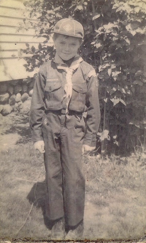 Charles poses in a Boy Scout uniform outside his family home. He began shoplifting at a very early age.