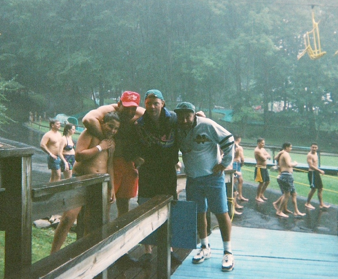 Big Al, second from left, poses next to Charles at a New York water park in the summer of 1994. At six foot two and 285 pounds, Big Al was Charles's chief enforcer.