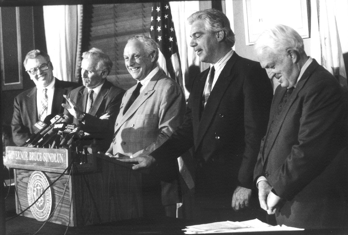 Governor Bruce Sundlun, center, created the Rhode Island Depositors Economic Protection Corporation, or DEPCO, to raise money for depositors by selling bonds. Courtesy of The Providence Journal/Mary Murphy.