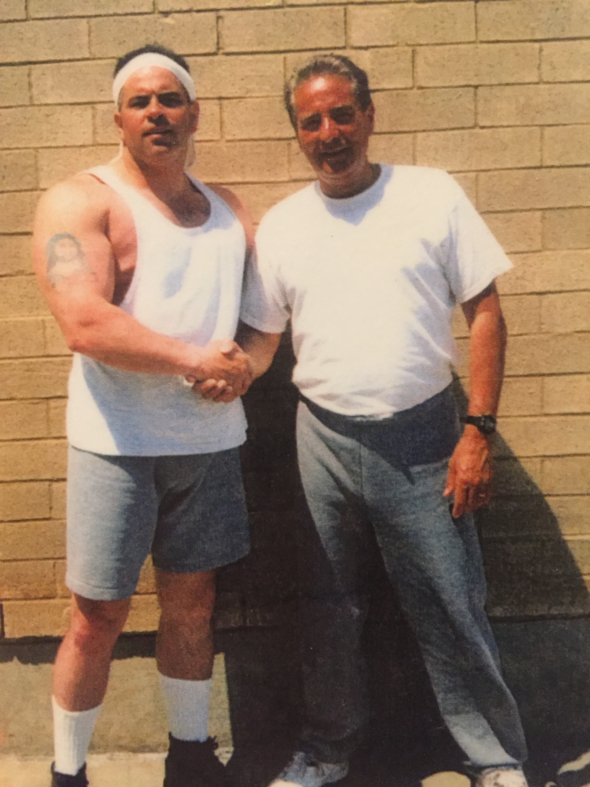 Tony Fiore poses with New York City crime boss John A. "Junior" Gotti, left, in a federal prison yard. Courtesy of The Providence Journal.