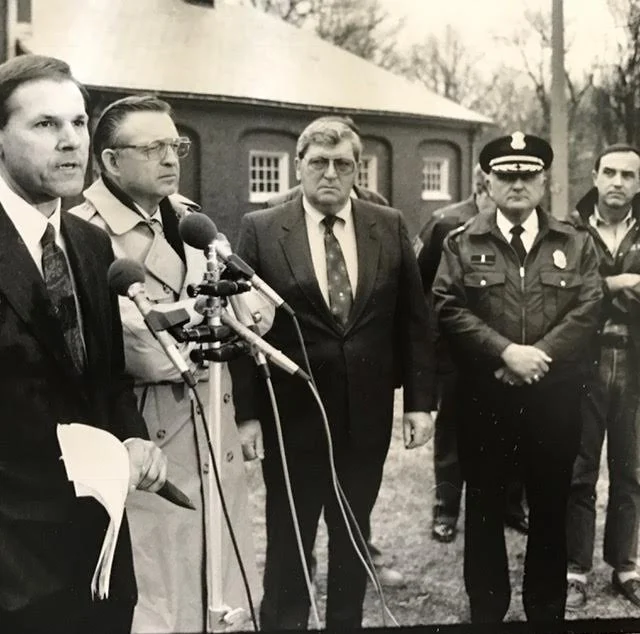 Tom Hughes of the FBI, far left, announces the Emerald Square Mall arrests at the Lincoln Woods state police barracks in 1991. Andrews is on the far right. Courtesy of Brian Andrews.