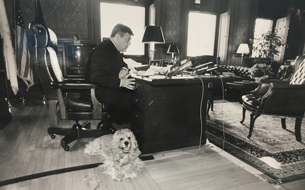 Buddy and his dog Tucker put in a day at City Hall. According to Mike Faella, Buddy would send his police security detail out to get hamburgers for his purebred cocker spaniels. Courtesy of The Providence Journal/Bob Thayer.