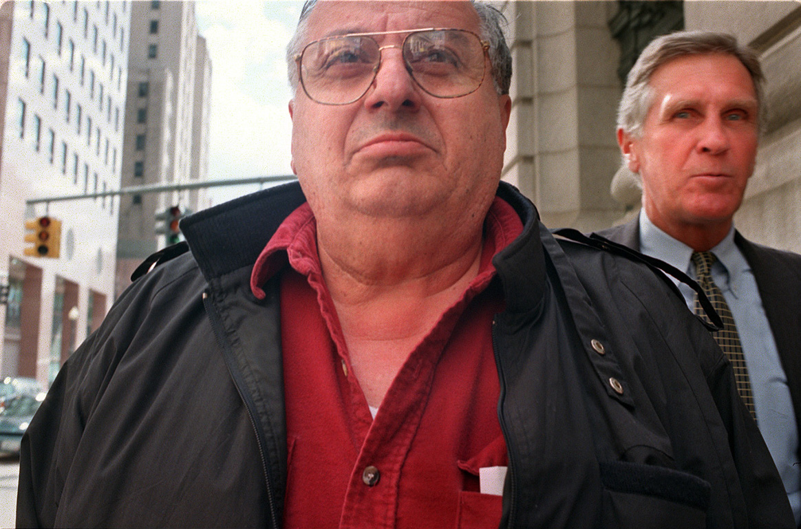 David Ead leaves Federal Court after being arrested by FBI agents. Ead was charged with laundering money to facilitate bribery. At right is Ead's lawyer, former attorney general James E. O'Neill. Courtesy of The Providence Journal/Andrew Dickerman.