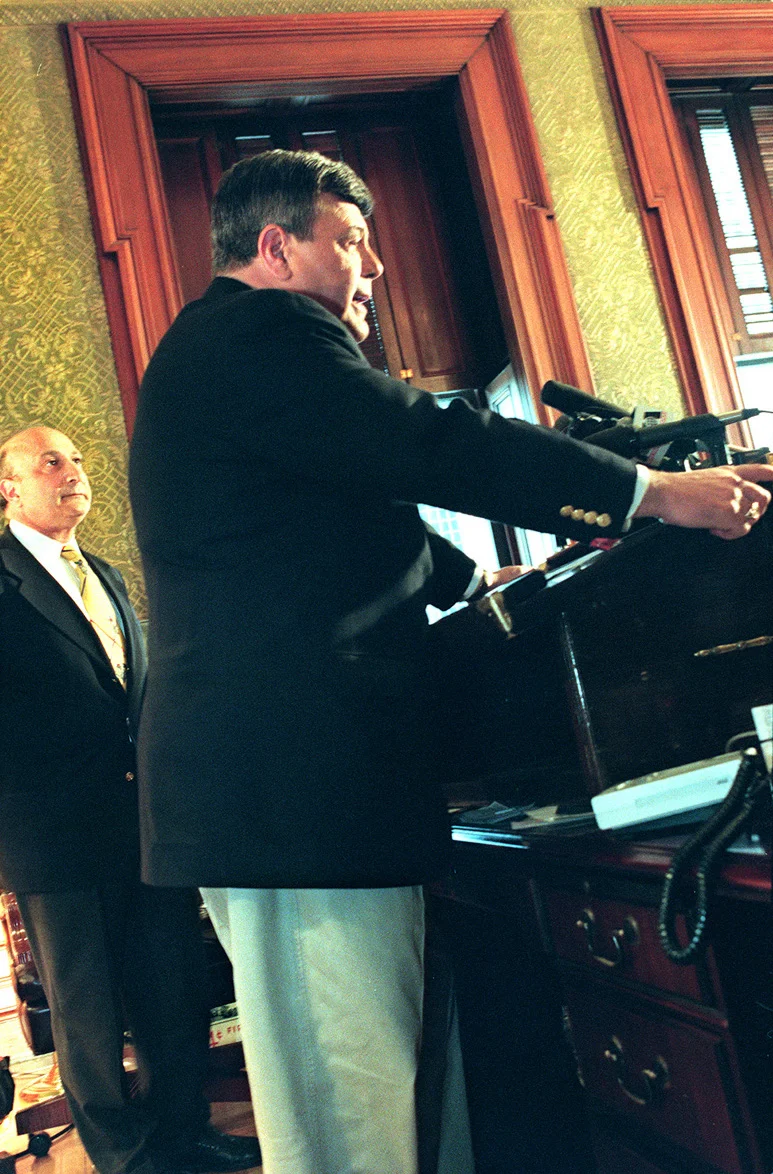 Buddy Cianci holds a press conference in his office at City Hall to discuss the FBI investigation and the arrests of two Providence tax officials. At his side is city solicitor Charles Mansolillo. Courtesy of The Providence Journal/Connie Grosch.