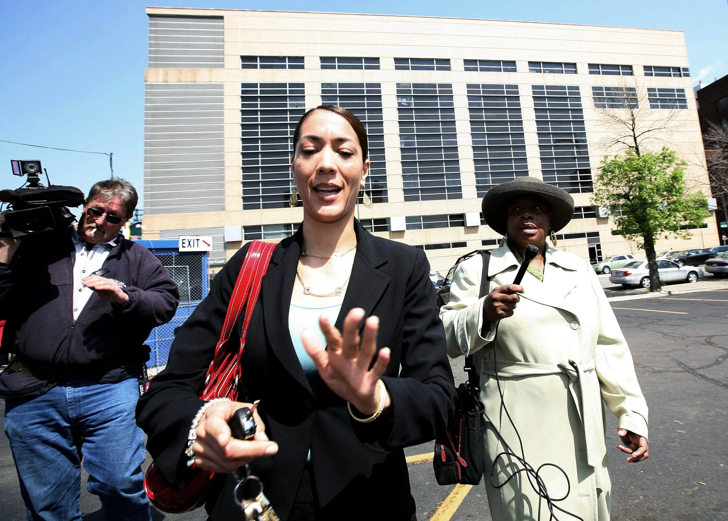 Christine is confronted by reporters while making her way from the 36th District Court in Detroit in May 2008. Lawyers representing Christine and Kwame were able to push back their preliminary hearing until September, which allowed Kwame to delay decisions about making a plea deal or resigning. Courtesy of the Detroit Free Press.