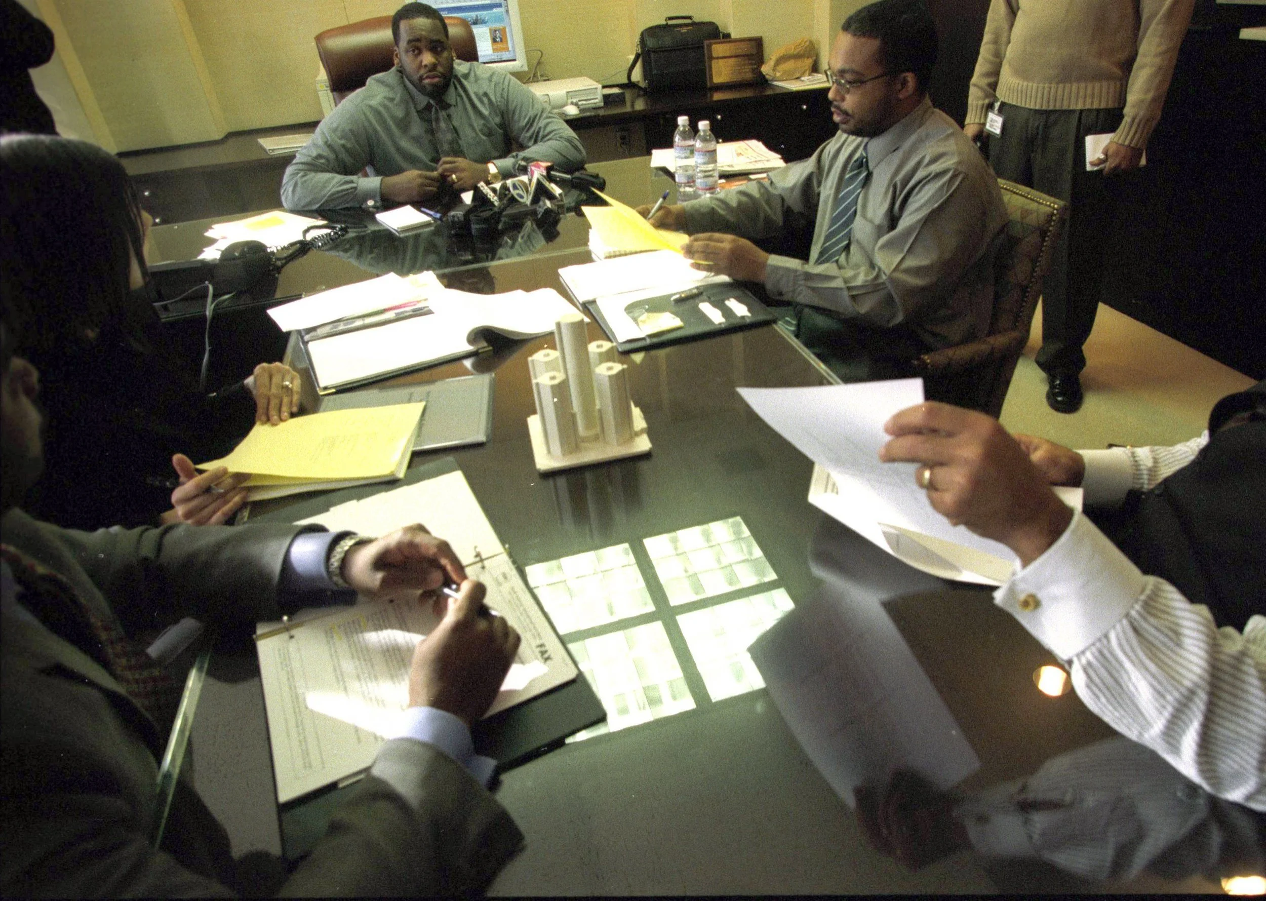Kwame often worked long hours at the office with Christine, left, and his aide DeDan Milton, right. He and Christine would often stay late after work to talk. Courtesy of the Detroit Free Press.