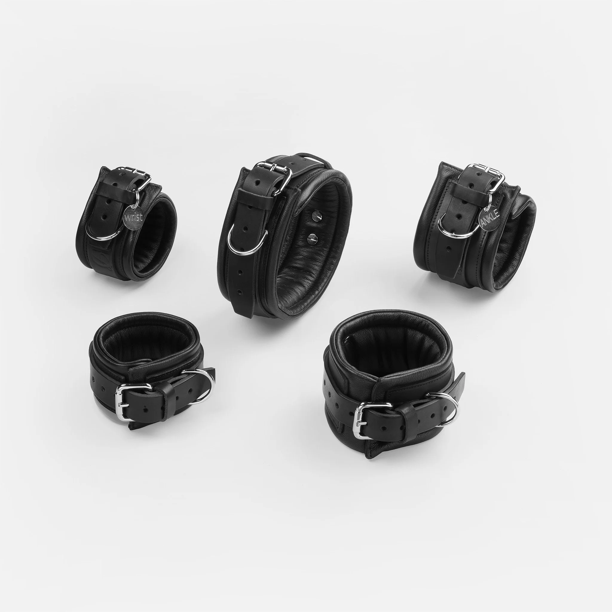 Complete black leather restraint set including wrist cuffs, ankle cuffs and collar