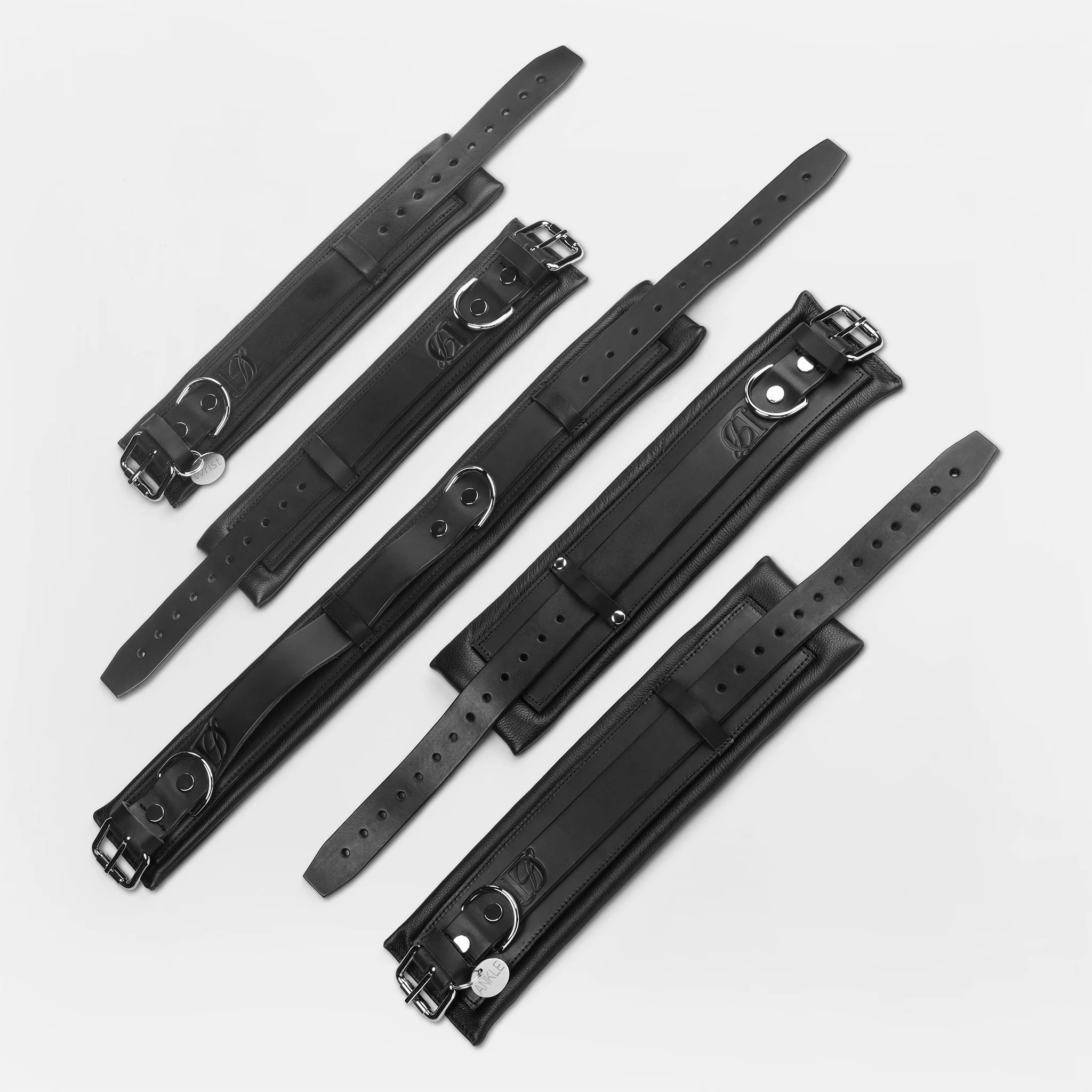 Black leather wrist, ankle cuffs and collar set by Dominatrix School