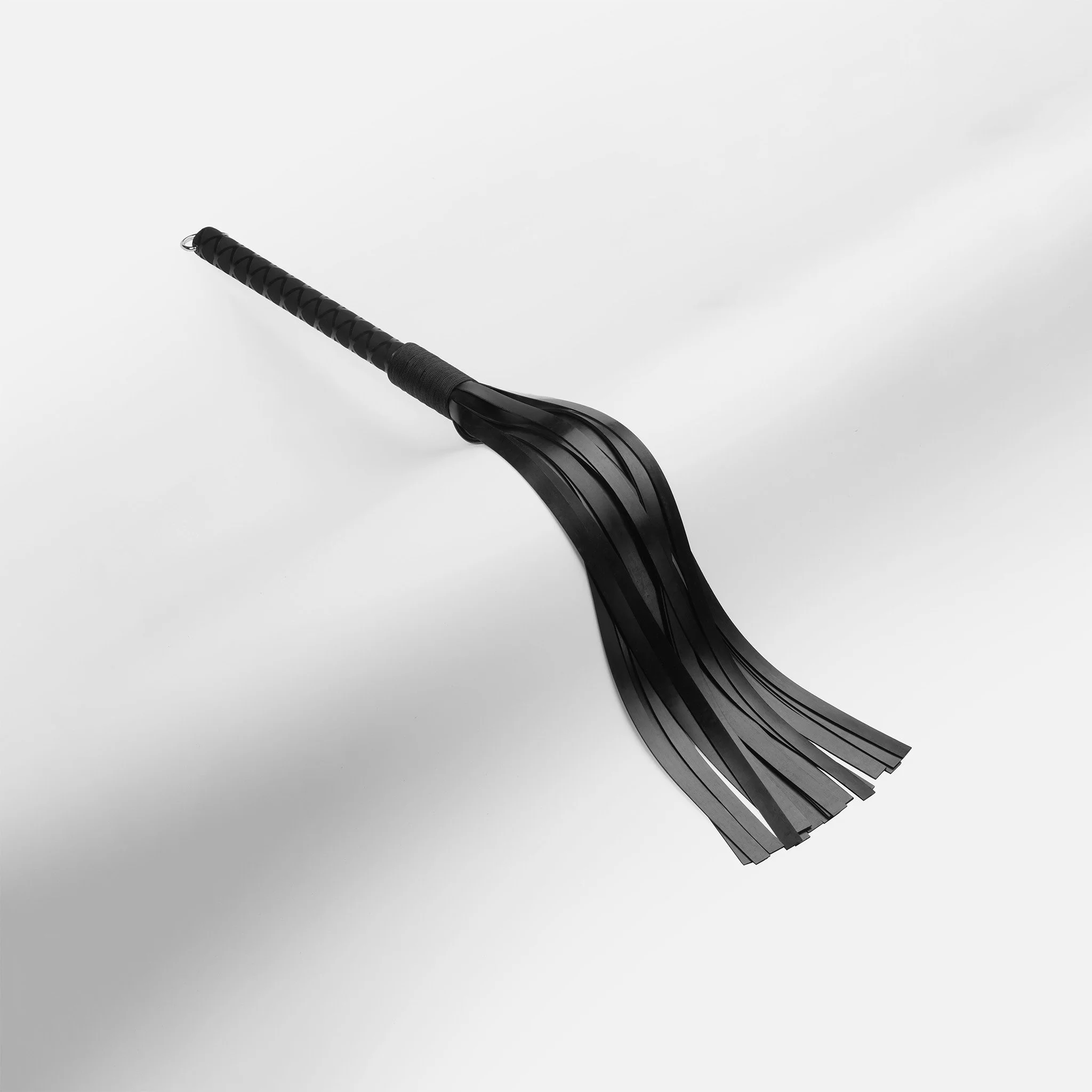 Heavy weight black latex flogger with dense tails for intense thud and sting